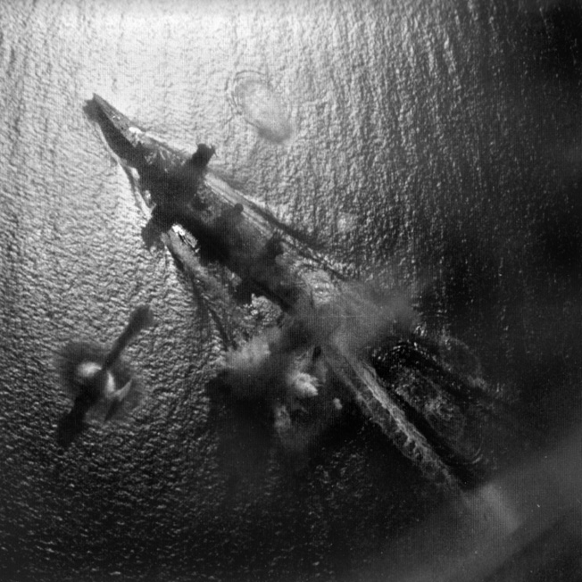 Hours before the nocturnal engagement in Surigao Strait, Japanese warships were attacked by aircraft from the carrier USS Enterprise. In this photo, a Japanese battleship, either Yamashiro or Fuso, takes evasive action as American bombs begin to fall. One hit was scored on Fuso, and the old battleship was later sunk by U.S. warships.