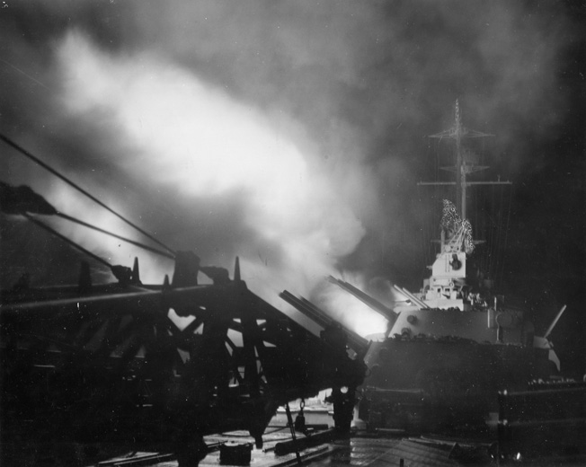 The new cruiser USS Columbia fires its weapons during a night exercise in 1943. As the war continued, U.S. Navy gunners became more proficient in night engagements, particularly with the addition of fire control radar aboard many ships.