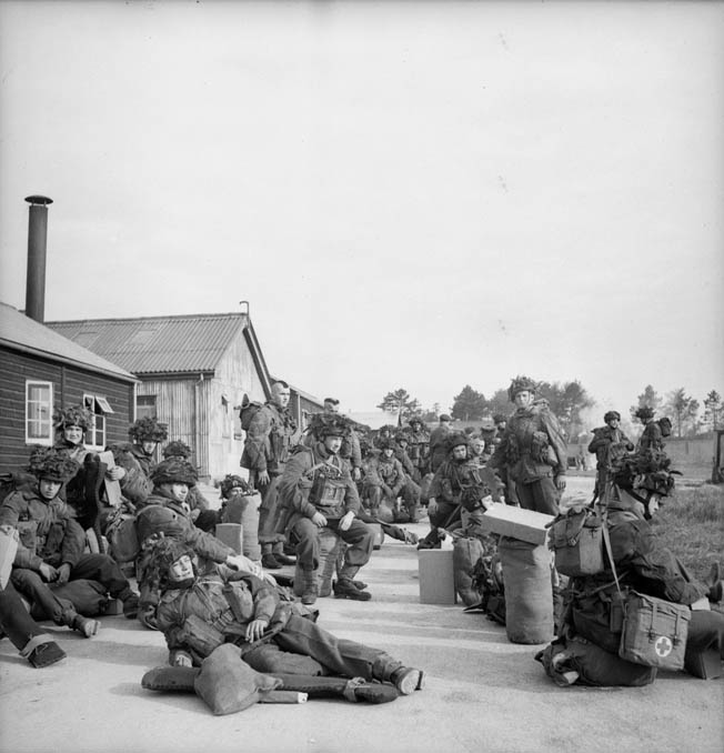 Troopers of the 1st Canadian Parachute Battalion relax in an assembly area as they await orders to proceed to their designated airfield and board transport planes for the perilous D-Day jump into Normandy.