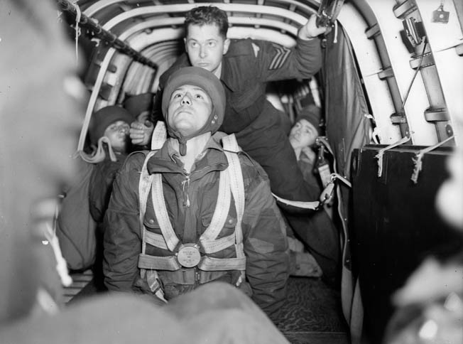 A private of the elite 1st Canadian Parachute Battalion prepares to jump from an Armstrong Whitworth Whitley bomber modified to carry paratroopers. 