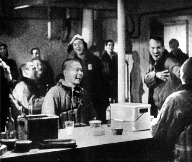 Japanese pilots listen to music on one of seven aircraft carriers on their way to Oahu.