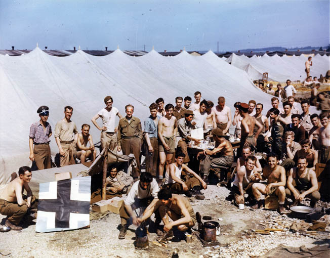 In this May 1945 photograph, recently liberated American prisoners of war await transportation during their journey home. Ray Miller was flown to Belgium and then transferred to Camp Lucky Strike near the port city of Le Havre, France, shortly after the German surrender and prior to his repatriation to the United States.