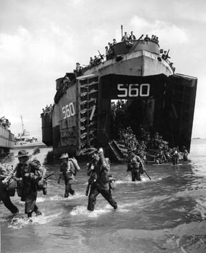 Australian troops pour ashore on Borneo from an American LST (Landing Ship, Tank), July 1, 1945. The PT boats of Squadron 27 provided close-in support to the invasion force.