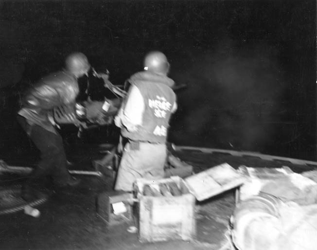 The gun crew on a PT boat fires one of its Oerlikon 20mm autocannons against Japanese-infested waters off New Guinea in November 1943. Note how reverberations shake the gunner’s body.