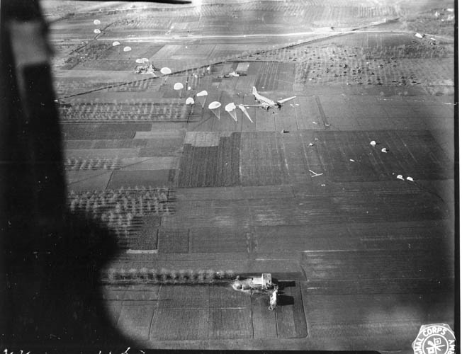 A stick of paratroopers hit the silk over Europe. During the Normandy jump, many sticks became separated and men had trouble finding their units in the dark. 