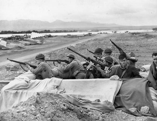 In the aftermath of the Pearl Harbor attack, U.S. Marines and soldiers stationed across Oahu were nervous and often fired at anything remotely suspicious. These troops man a sandbag gun emplacement adjacent to an airfield, their rifles and machine gun at the ready.