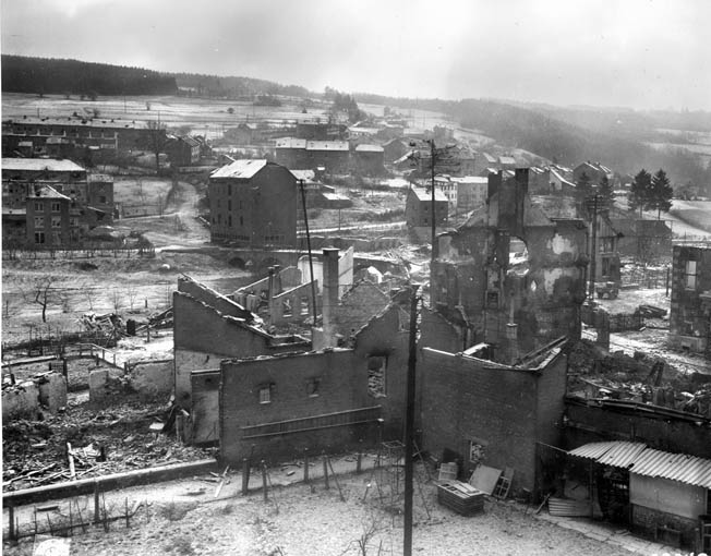 The shattered Belgian town of Stavelot is shown during the Battle of the Bulge. In the center at left is the bridge over the Ambléve River.