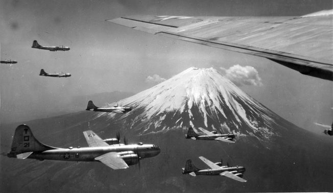 B-29s passing Mount Fuji near Tokyo, 1945. The B-29 force started out with high-altitude, daylight precision bombing tactics derived from experience in Europe but soon switched to night incendiary bombing missions. 