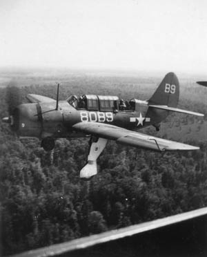 SB2C-1C Helldiver of Squadron VB-80 on approach for landing, with gear down.