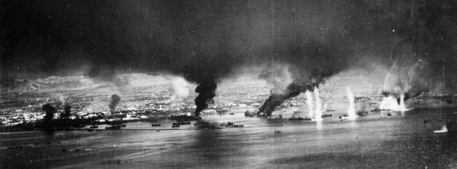 Fires send black smoke aloft from Japanese ships and facilities at Manila Bay on November 13, 1944, following an attack by SB2C Helldiver dive-bombers.