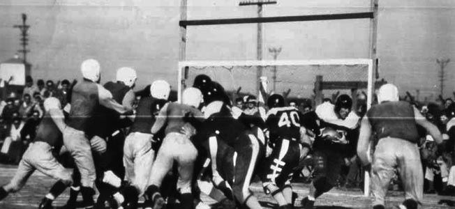 A newspaper photo of action during the “Barbwire Bowl Classic” played at Stockton Ordnance Depot POW camp on January 13, 1946. 