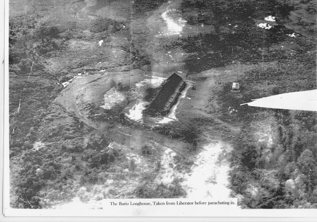 Jack Tradrea, a member of the Z Special Unit, took this photograph from the B-24 bomber that transported the covert unit to Borneo. The image shows the longhouse where the group spent its first night in Borneo. Tradrea accompanied Tom Harrisson during this mission to the Japanese-held island.