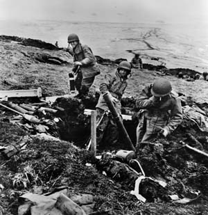 A U.S. mortar crew on Attu lobs its ordnance against a Japanese position.