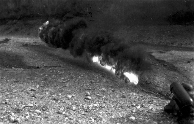 The range of the portable flamethrowers was approximately 20-25 yards, as shown in this training photograph. 