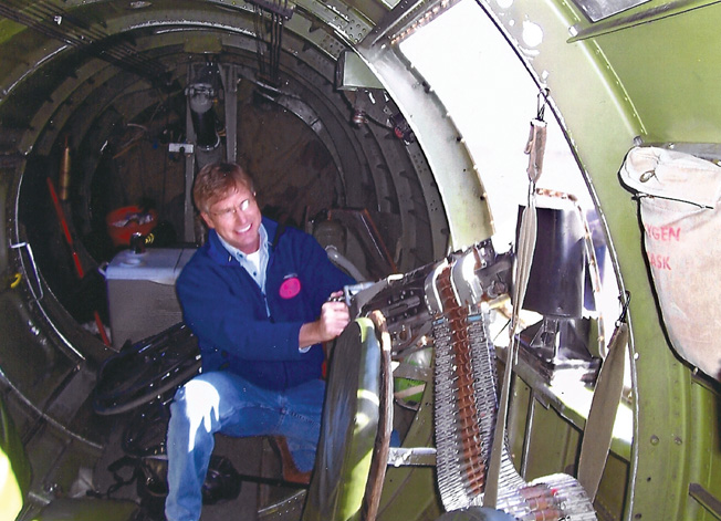 Trammell poses with one of the .50-caliber waist guns. Note the narrowness of the fuselage.