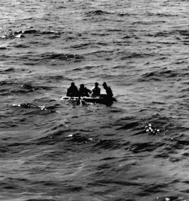 Survivors of the USS Franklin paddle in a raft thrown to them by the Santa Fe. 