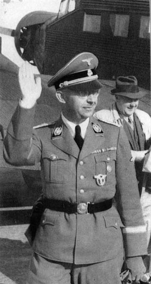 Exiting his personal Ju-52 aircraft during a tour of the Eastern Front, a smiling Himmler responds to a salute of soldiers. Behind him is his personal masseur and confidant, Dr. Felix Kersten. 