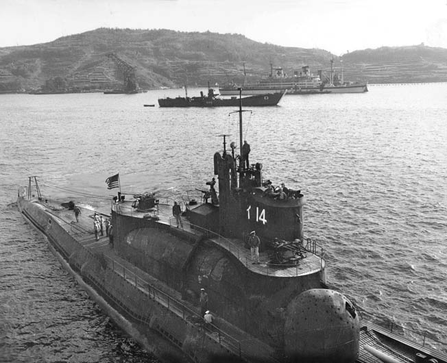 American naval personnel inspect the I-14, photographed in November 1945. The large structure beneath the conning tower was the hangar that could hold three planes with folded wings. The sub carried enough fuel to sail around the globe one and a half times.