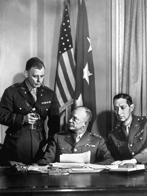 Ike meets with his chief of staff, Brig. Gen. Walter Bedell Smith (left) and Maj. Gen. Mark Wayne Clark, Ike's deputy and commander of II Corps.