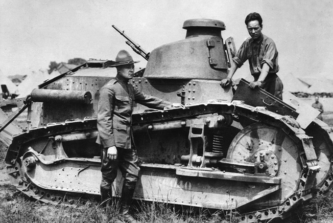 Lt. Col. Eisenhower (in campaign hat) stands next to a Renault FT-17 light tank during maneuvers at Camp Colt, Pennsylvania, in 1918. His dour expression may be due to his being denied the chance to see combat in France.