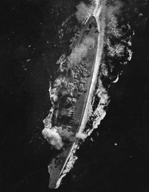 A view of the Yamato as a bomb explodes near her forward 460mm gun turret during the Battle of the Sibuyan Sea on October 20, 1944. Although considered huge when she was commissioned in December 1941 (she was 266 feet longer and 44,000 tons heavier than the USS Texas, which had been commissioned in 1914), by the time she saw action, American battleships of the Iowa class were nearly as big.