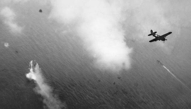 American dive- bombers, probably from the Yorktown, bank into the attack on the Yamato (left).