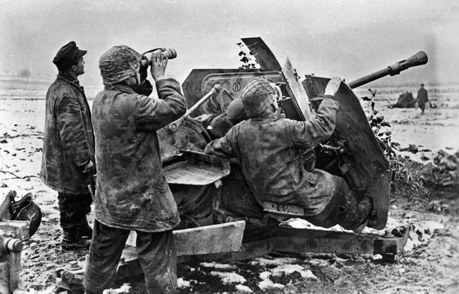 German troops manning a 3.7cm Flak 36/37 anti-aircraft gun in the Saarland are on the alert for an American aerial assault, December 1944. 