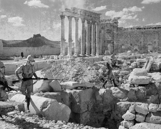 British troops search for snipers amid the ancient ruins of the Temple of Baal Shamin at Palmyra, Syria, in July 1941.