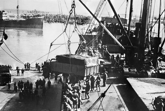 German military vehicles are offloaded from cargo ships at the port of Tripoli, Libya, April 1, 1941. By disrupting the Axis supply line, the Allies gained a matériel advantage over the Germans and Italians in the North African Campaign.