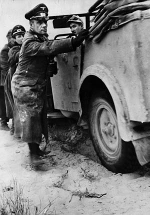 Although a brilliant tactician, General Erwin Rommel (shown here helping to push his command car out of deep desert sand in February 1942) was unable to overcome his dwindling resources. 