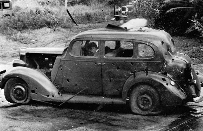 Three civilians lie dead in their car after it was hit by fragments from falling antiaircraft munitions.