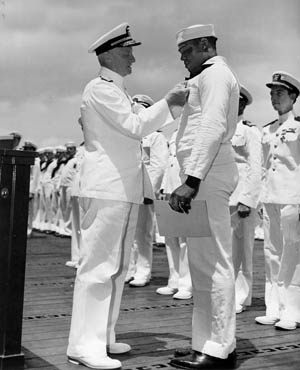 Mess Attendant Dorrie Miller became the first African American to receive the Navy Cross for his actions in the attack.