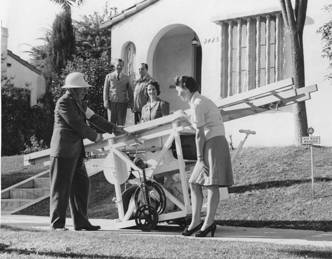 Being the most susceptible to Japanese attack, the West Coast was the best prepared. Here a Civil Defense warden shows Southern California civilians how to use a homemade fire-fighting apparatus.