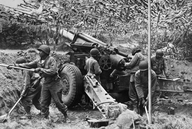 Men of the 333rd emplace one of their 155mm howitzers in a Normandy field, June 28, 1944. The battalion soon proved its worth in battle and their services were in high demand by white infantry units.