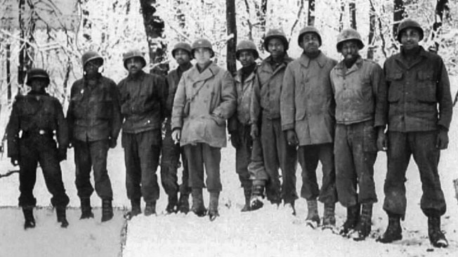 Men of C Battery, 333rd, pose for a photo with Captain William G. McLeod, center, in a wintry landscape about the time the massacre occurred. McLeod greatly respected his men and the feeling was mutual.