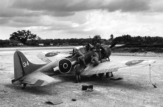 Crew members of a New Zealand squadron work on their new Douglas SBD Dauntless dive bomber at Espiritu Santo, March 1944.