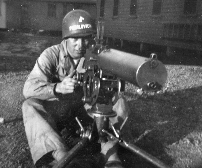 Private Puhalovich poses behind a .30-caliber water-cooled machine gun during basic training at Camp Adair, Oregon, 1943. 