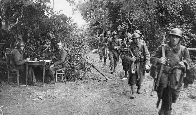 A French patrol moves through a wooded area to make contact with le Boche, June 3, 1940.