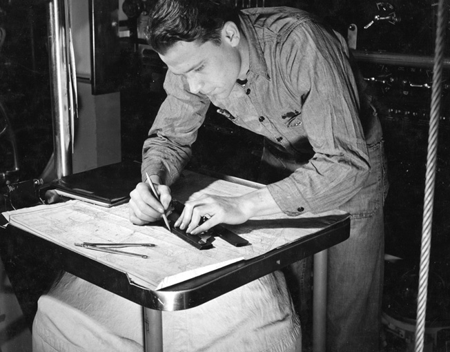 An officer charts a course aboard the Cachalot-class V-boat Cuttlefish (SS-171), June 8, 1943.
