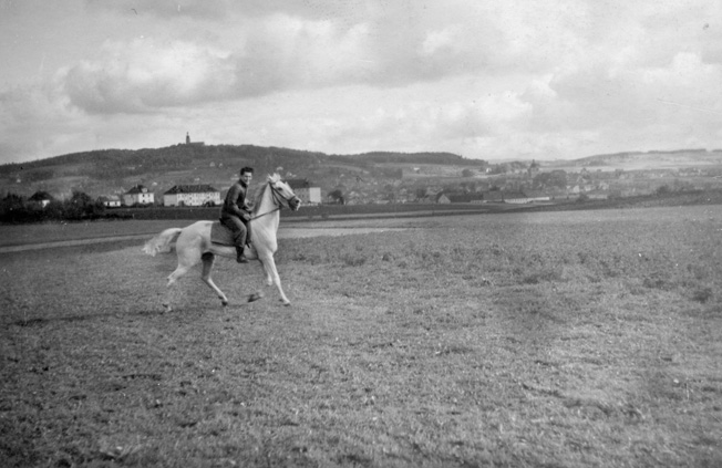 Private Sevel rides a horse after hostilities ended in Europe. He was put in charge of a horse stable to keep him busy during the occupation of Germany.