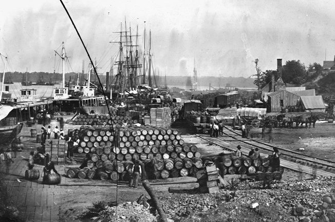 A vast mound of military supplies is unloaded at the major Union Army depot at City Point, Va., during the 1864 siege of Petersburg. By then, improvements instituted by Montgomery Meigs had gone into effect.