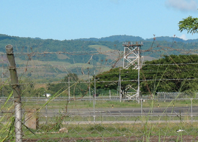 The skeleton of the Henderson Field control tower, built in 1943, sits on the edge of the runway of what is now known as Honiara International Airport.