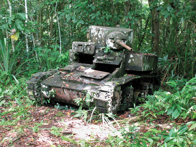 The rusted hulk of an M3 Stuart light tank is slowly being reclaimed by the jungle on the edge of a Bairoko Harbor village, New Georgia Island. 