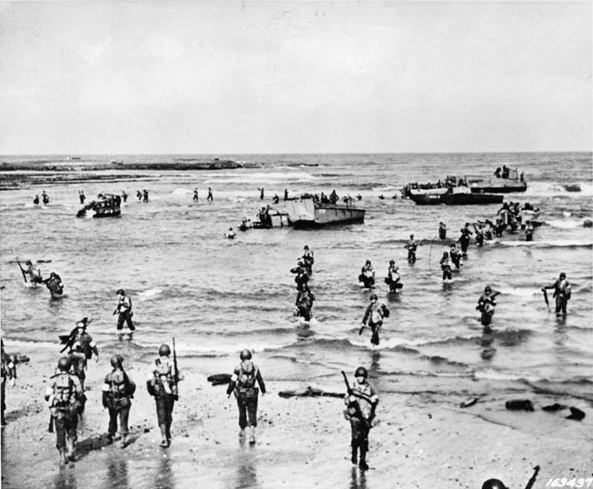 The U.S. Army had virtually no experience in amphibious operations by the time Operation Torch commenced in November 1942, and the extent of that inexperience was painfully evident during the opening hours of the offensive in North Africa. In this photo, American soldiers walk and stumble through the surf on a North African beach. When General Lucian Truscott came ashore, he found chaos.