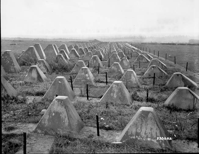 Concrete antitank obstacles such as these studded the German West Wall, or Siegfried Line, along with wide ditches, fortified strongpoints, and mines. The Siegfried Line was one of the many major construction projects supervised by Dr. Todt. 