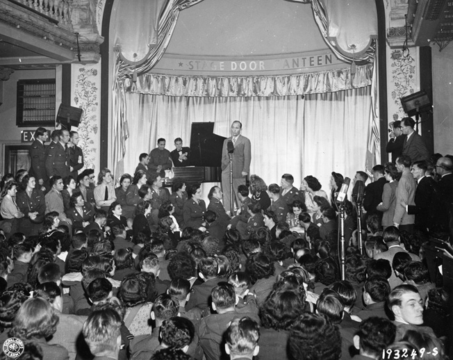 Bing Crosby performs for Allied troops during the opening performance of the USO Stage Door Canteen in Picadilly, London, August 1944.