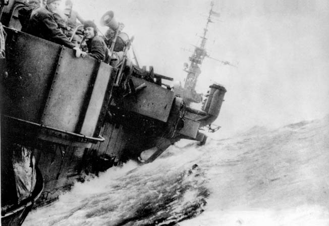 In June 1945, Sailors hang on as the aircraft carrier USS Langley rolls sharply to port during Typhoon Connie, a second major Pacific storm that wracked the ships of the U.S. Navy’s Third Fleet during World War II.