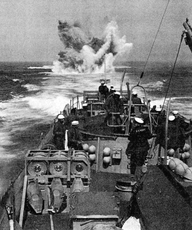 Sailors aboard the submarine chaser PC-1264 observe one of their depth charges exploding during an antisubmarine drill during the ship’s shakedown cruise.