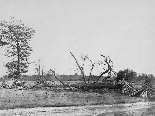A blurry horseman is visible at the far left of this period photograph of hastily constructed breastworks on the far left of the Confederate line at Cold Harbor.