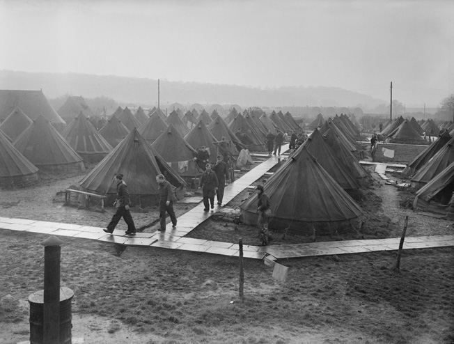 An unidentified POW camp in Britain, photographed in December 1945. While most of the camp consisted of tents, Nissen huts—prefabricated metal buildings, visible in the distance—also housed prisoners.